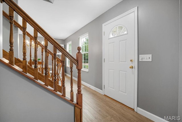 301 Sassafras Parc Dr, Ofallon, MO 63368 - foyer with baseboards, wood finished floors, and stairs