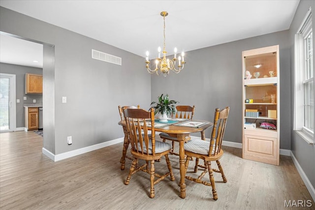 301 Sassafras Parc Dr, Ofallon, MO 63368 - dining space featuring light wood finished floors, a chandelier, and baseboards