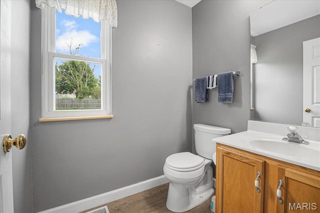 301 Sassafras Parc Dr, Ofallon, MO 63368 - bathroom with toilet, vanity, baseboards, and wood finished floors