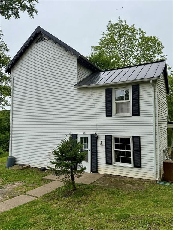 10321 Old 79, Hannibal, MO 63401 - view of front of house with a standing seam roof, a front yard, and metal roof