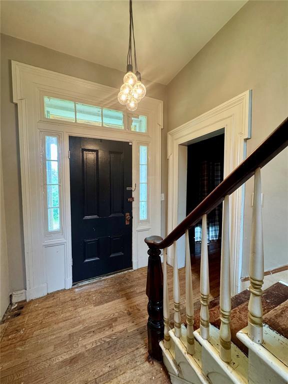 10321 Old 79, Hannibal, MO 63401 - foyer entrance with stairs, wood finished floors, and a chandelier