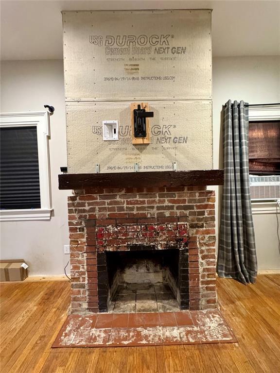 10321 Old 79, Hannibal, MO 63401 - detailed view of wood finished floors, a brick fireplace, and cooling unit
