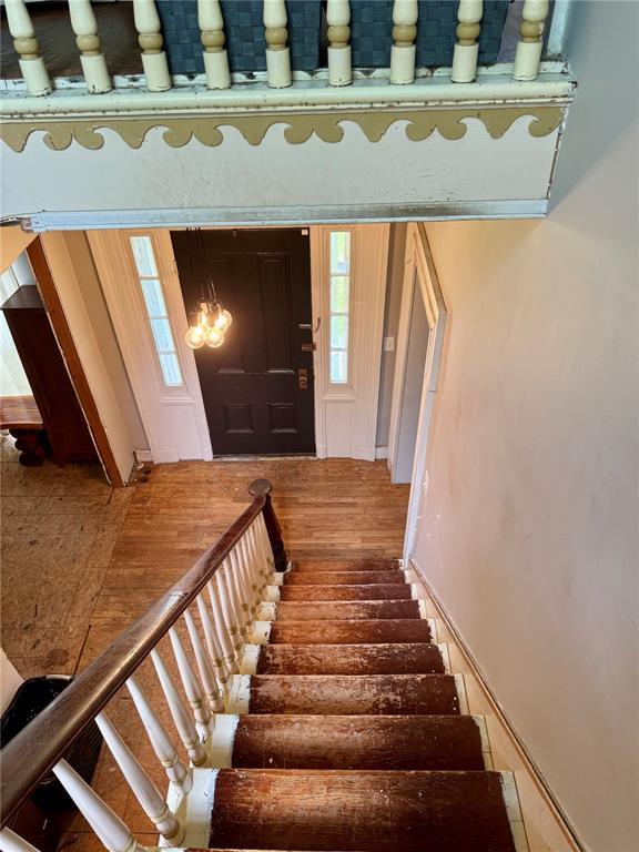 10321 Old 79, Hannibal, MO 63401 - stairs featuring wood finished floors and a chandelier