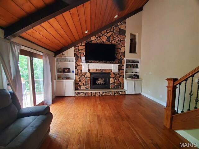 3 Janney Cir, Canton, MO 63435 - living area with wood-type flooring, a stone fireplace, stairs, wood ceiling, and baseboards