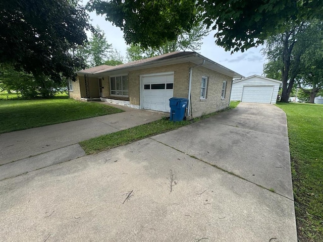 511 N 5th St, La Grange, MO 63448 - view of front of house with a front yard, brick siding, a garage, and an outbuilding