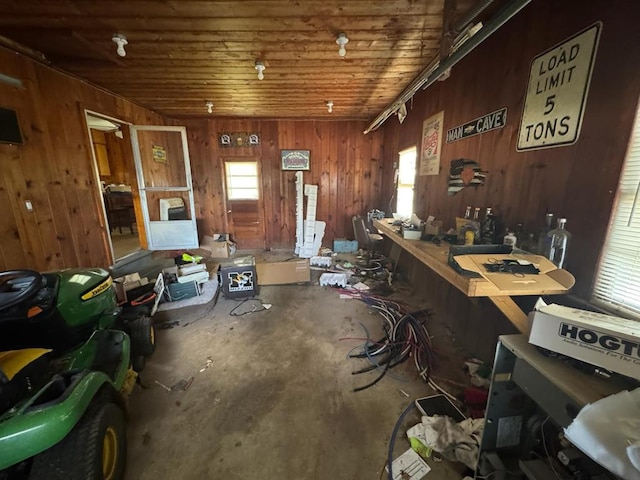 511 N 5th St, La Grange, MO 63448 - misc room featuring unfinished concrete flooring, wood walls, a workshop area, and wood ceiling