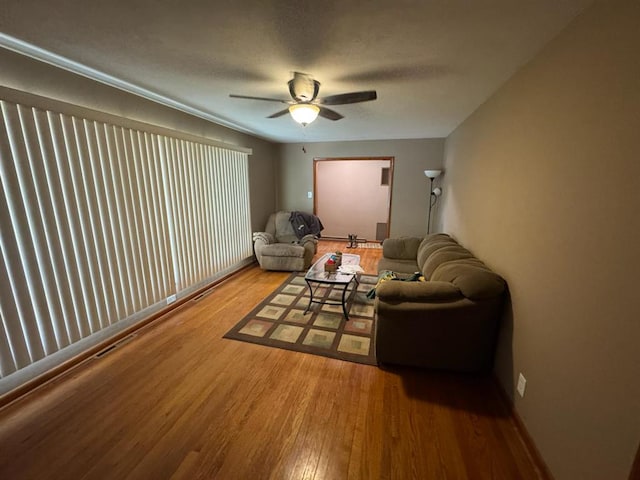 511 N 5th St, La Grange, MO 63448 - living area with wood finished floors, a ceiling fan, and baseboards