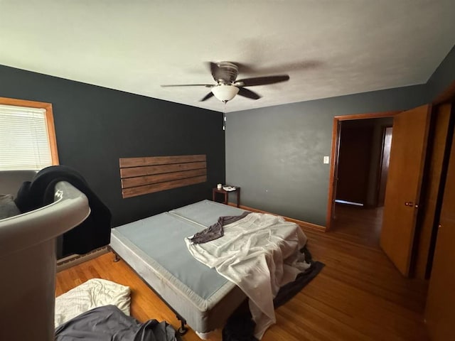 511 N 5th St, La Grange, MO 63448 - bedroom with wood finished floors, a ceiling fan, and baseboards