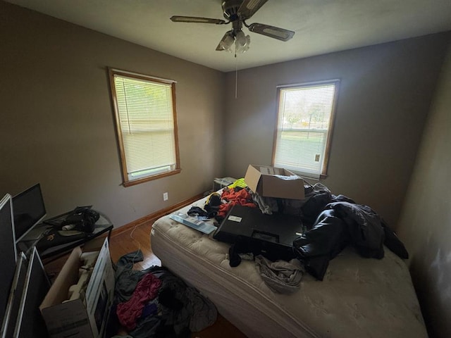 511 N 5th St, La Grange, MO 63448 - bedroom with wood finished floors, baseboards, and a ceiling fan