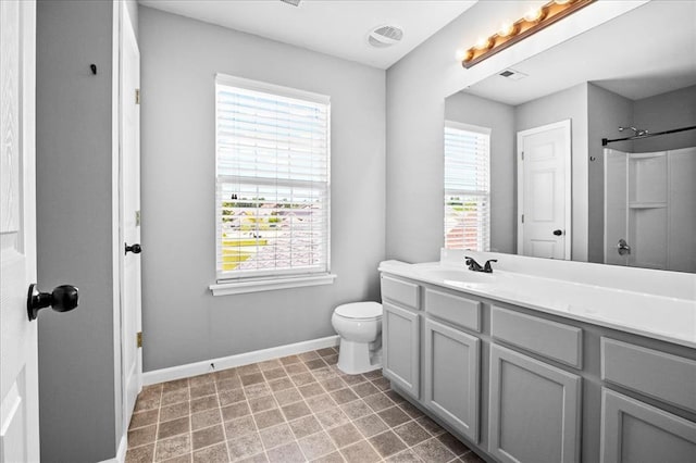 1406 Tisbury Cir, Ofallon, MO 63366 - bathroom with baseboards, toilet, vanity, and a shower