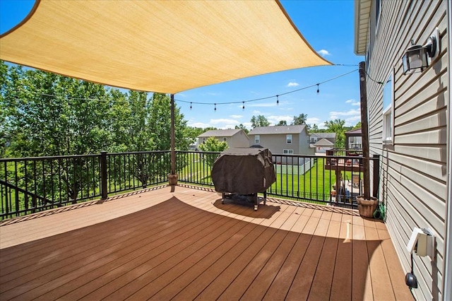 1406 Tisbury Cir, Ofallon, MO 63366 - wooden terrace featuring a grill, a lawn, and a residential view