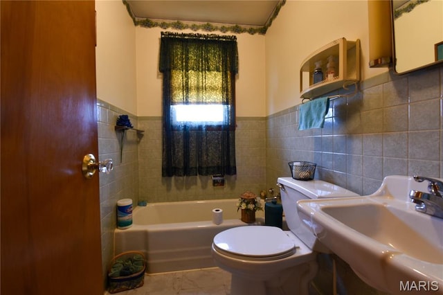 411 S Walnut St, Mount Olive, IL 62069 - full bath featuring a sink, tile walls, toilet, a tub, and a wainscoted wall