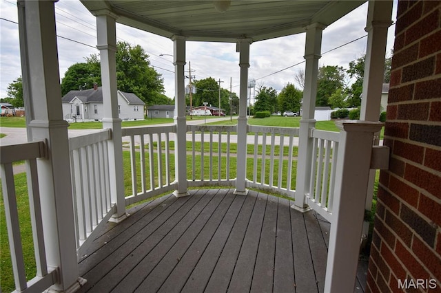 411 S Walnut St, Mount Olive, IL 62069 - wooden porch featuring a residential view and a lawn