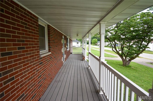 411 S Walnut St, Mount Olive, IL 62069 - wooden porch with a lawn