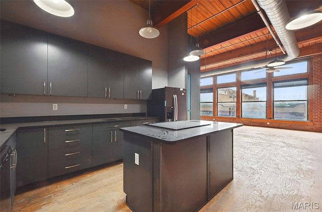1312 Washington Ave Unit 2A, Saint Louis, MO 63103 - kitchen with stainless steel fridge with ice dispenser, light wood finished floors, hanging light fixtures, a center island, and beam ceiling