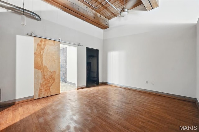 1312 Washington Ave Unit 2A, Saint Louis, MO 63103 - unfurnished room featuring wood finished floors, high vaulted ceiling, a barn door, and a wood ceiling with exposed beams