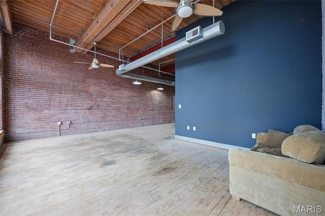 1312 Washington Ave Unit 2A, Saint Louis, MO 63103 - basement featuring brick wall, ceiling fan, wood finished floors, and wooden ceiling