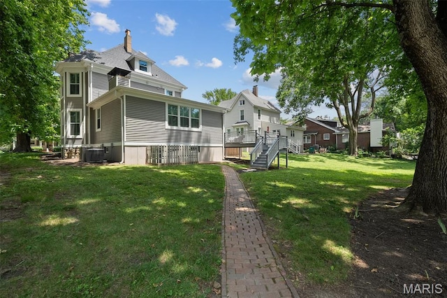 102 Portland Ter, Webster Groves, MO 63119 - back of property featuring a lawn, a chimney, a wooden deck, and stairs