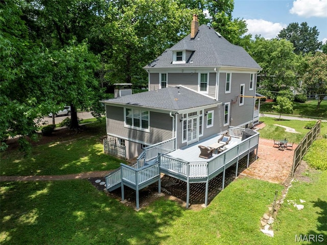 102 Portland Ter, Webster Groves, MO 63119 - back of house featuring a chimney, a deck, a lawn, and roof with shingles