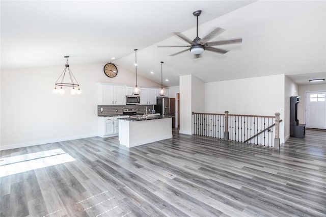 312 Andy Habsieger St, Festus, MO 63028 - kitchen with appliances with stainless steel finishes, open floor plan, dark countertops, white cabinetry, and lofted ceiling