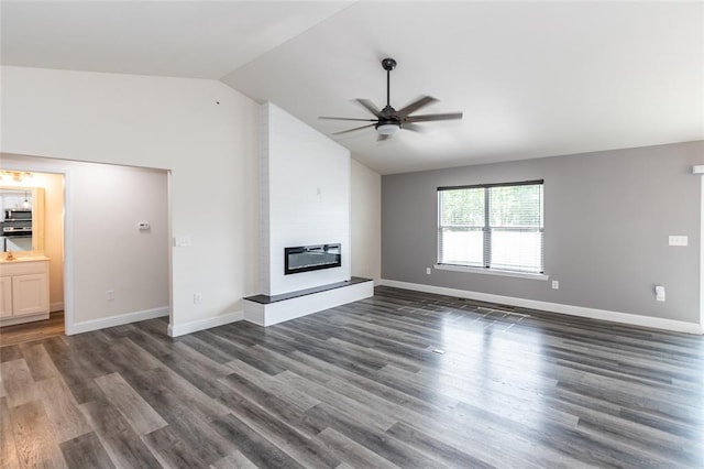 312 Andy Habsieger St, Festus, MO 63028 - unfurnished living room with a ceiling fan, vaulted ceiling, a large fireplace, dark wood-type flooring, and baseboards