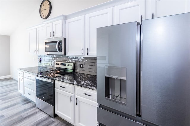 312 Andy Habsieger St, Festus, MO 63028 - kitchen with stainless steel appliances, dark stone counters, tasteful backsplash, light wood-style flooring, and white cabinets