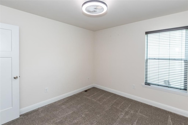 312 Andy Habsieger St, Festus, MO 63028 - spare room with dark colored carpet, baseboards, and healthy amount of natural light