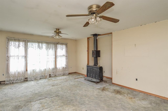 4090 E Pelot Ln, Alton, IL 62002 - unfurnished living room with baseboards, a wood stove, carpet, and ceiling fan