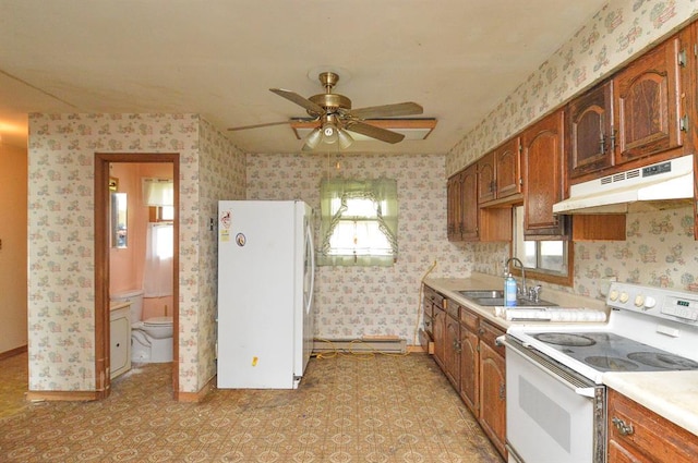 4090 E Pelot Ln, Alton, IL 62002 - kitchen featuring white appliances, a sink, under cabinet range hood, light countertops, and wallpapered walls