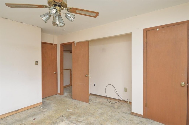 4090 E Pelot Ln, Alton, IL 62002 - unfurnished bedroom featuring baseboards, concrete flooring, and a ceiling fan