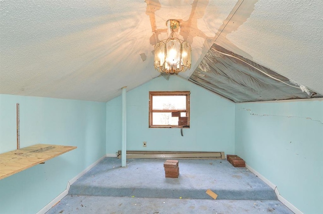 4090 E Pelot Ln, Alton, IL 62002 - additional living space featuring a chandelier, baseboards, a textured ceiling, and vaulted ceiling