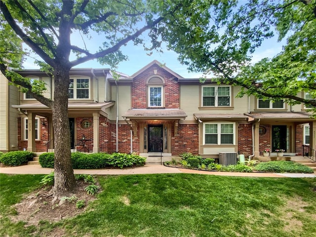 5315 N Kenrick Parke Dr, Saint Louis, MO 63119 - view of front of home with central air condition unit, a front lawn, and brick siding