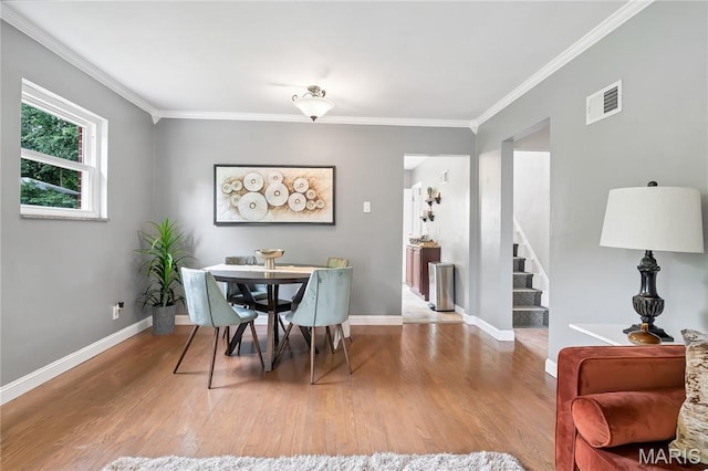 804 Tavalon Ave, Rock Hill, MO 63119 - dining room featuring wood finished floors, ornamental molding, and stairway