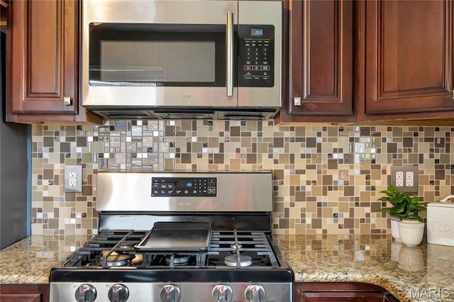 804 Tavalon Ave, Rock Hill, MO 63119 - kitchen with appliances with stainless steel finishes, decorative backsplash, and light stone counters