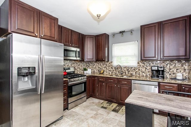 804 Tavalon Ave, Rock Hill, MO 63119 - kitchen with appliances with stainless steel finishes, decorative backsplash, light stone counters, and dark brown cabinets