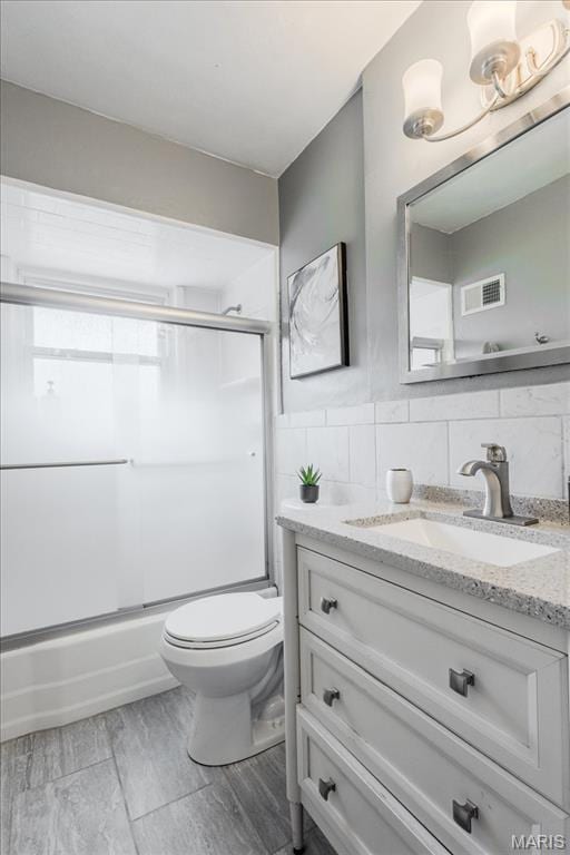 804 Tavalon Ave, Rock Hill, MO 63119 - full bath featuring vanity, bath / shower combo with glass door, wood finished floors, and tile walls