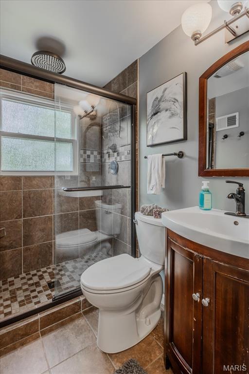 804 Tavalon Ave, Rock Hill, MO 63119 - bathroom with a stall shower, vanity, and tile patterned floors