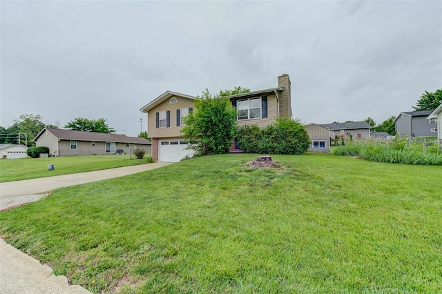 1625 Knightwood Ln, Ofallon, MO 63366 - view of front of home with a chimney, a garage, driveway, and a front lawn