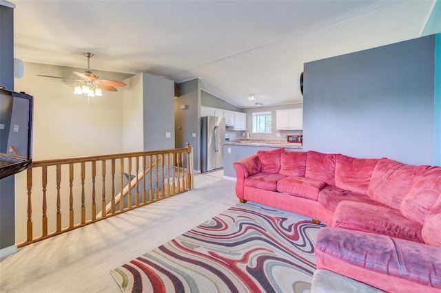 1625 Knightwood Ln, Ofallon, MO 63366 - living area featuring light carpet, vaulted ceiling, ceiling fan, and baseboards