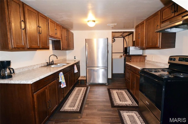 1116 E Springfield Rd, Sullivan, MO 63080 - kitchen with freestanding refrigerator, black range with electric cooktop, under cabinet range hood, light countertops, and dark wood-style floors