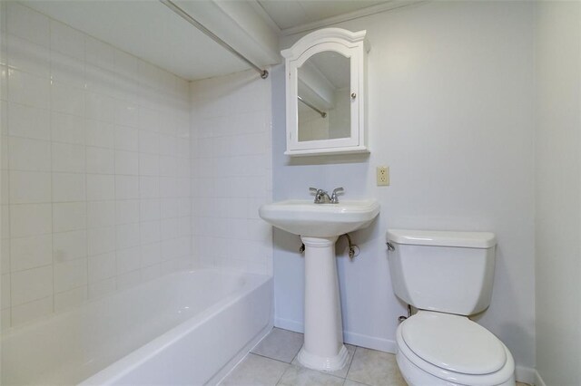 2447 Hartland Ave, Sycamore Hills, MO 63114 - bathroom featuring toilet, baseboards, tile patterned flooring, a sink, and shower / bathtub combination