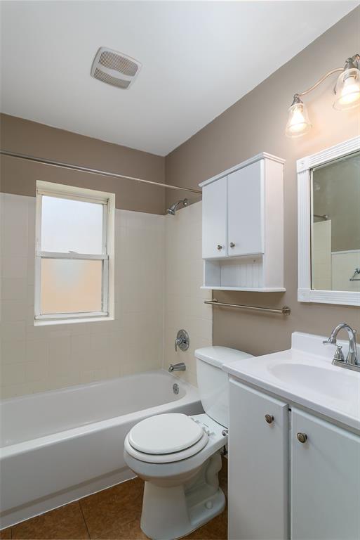2447 Hartland Ave, Sycamore Hills, MO 63114 - full bath with vanity, toilet, shower / bathtub combination, and tile patterned floors