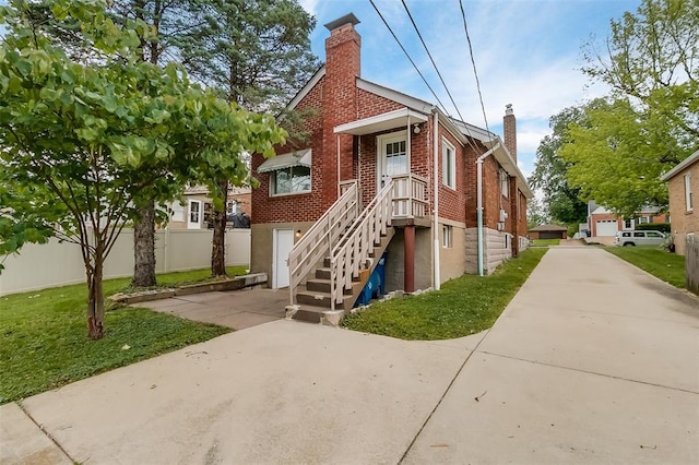 2447 Hartland Ave, Sycamore Hills, MO 63114 - view of front facade featuring a chimney and brick siding