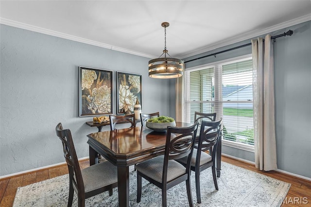 4667 Meramec Blvd, Eureka, MO 63025 - dining space featuring a chandelier, baseboards, crown molding, and wood finished floors