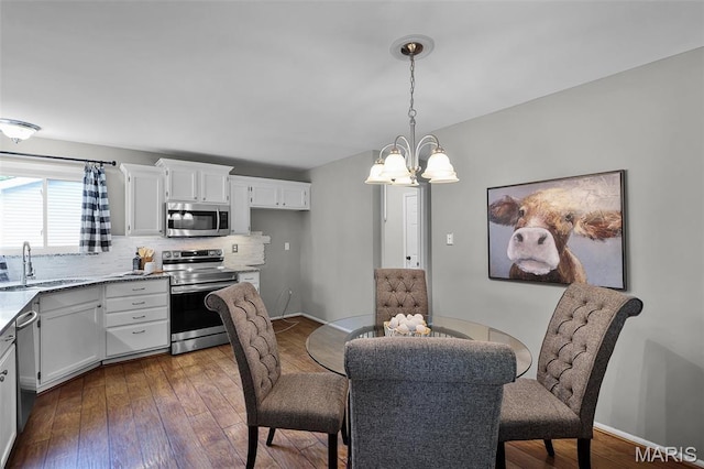4667 Meramec Blvd, Eureka, MO 63025 - dining room featuring dark wood-type flooring, a chandelier, and baseboards