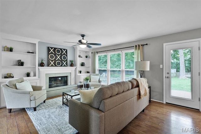 4667 Meramec Blvd, Eureka, MO 63025 - living area featuring healthy amount of natural light, hardwood / wood-style floors, and a glass covered fireplace