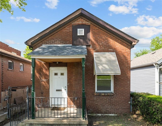5337 Arsenal St, Saint Louis, MO 63139 - view of front of property featuring brick siding, a gate, and a shingled roof
