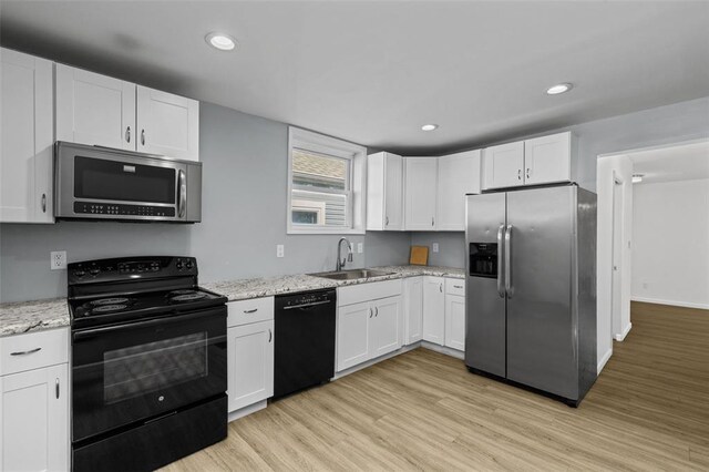 5337 Arsenal St, Saint Louis, MO 63139 - kitchen featuring black appliances, a sink, light wood-style floors, white cabinetry, and recessed lighting
