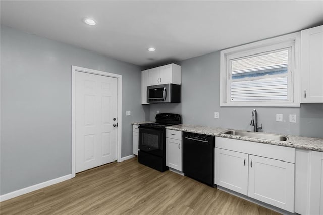 5337 Arsenal St, Saint Louis, MO 63139 - kitchen with black appliances, light wood-style flooring, a sink, white cabinets, and recessed lighting