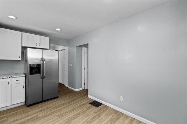 5337 Arsenal St, Saint Louis, MO 63139 - kitchen featuring stainless steel refrigerator with ice dispenser, light wood-style flooring, white cabinetry, baseboards, and recessed lighting